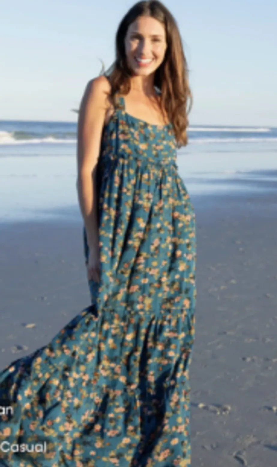 Woman in dark turquoise floral dress by Natural Life