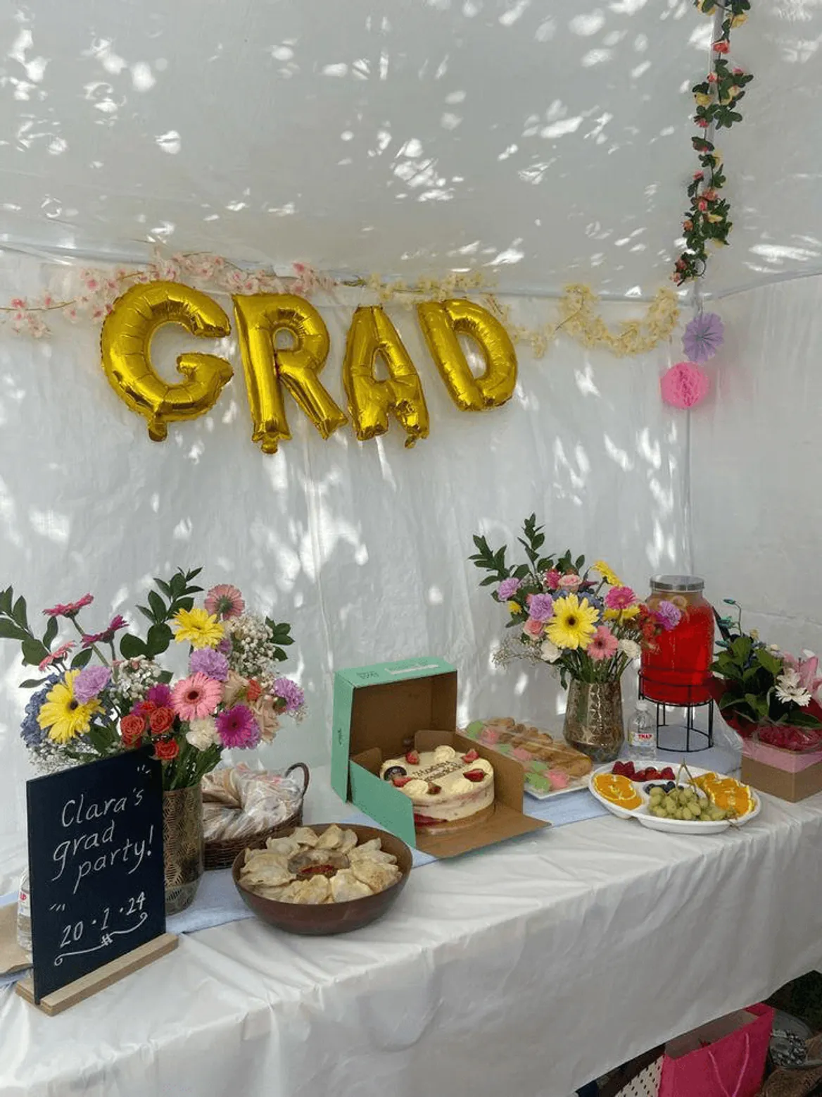 Graduation party dessert table with floral decorations