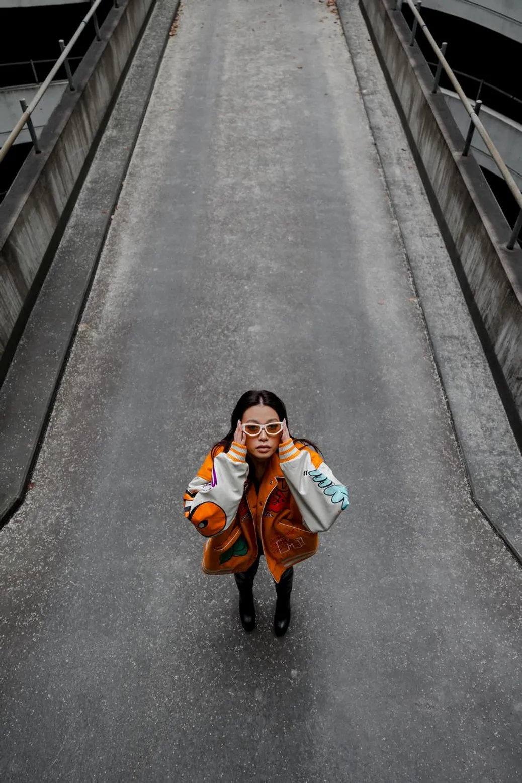 Bomber jacket paired with a denim maxi skirt and knee-high boots for a cool girl vibe
