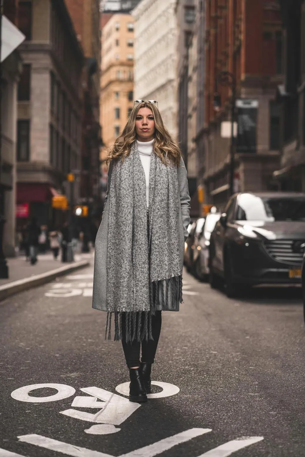 Fashionable woman in double denim with a leopard-print vest, styled with deep indigo tones