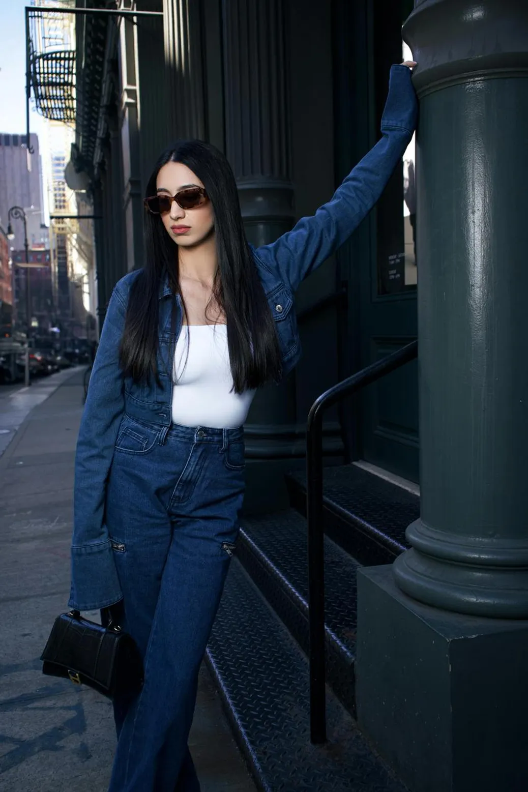 Double denim outfit with a denim shirt and maxi skirt, paired with bold accessories