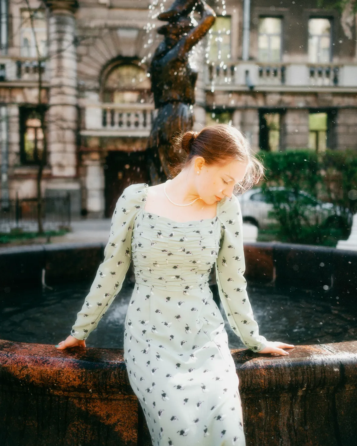 Woman wearing a green polka dot dress in a professional setting