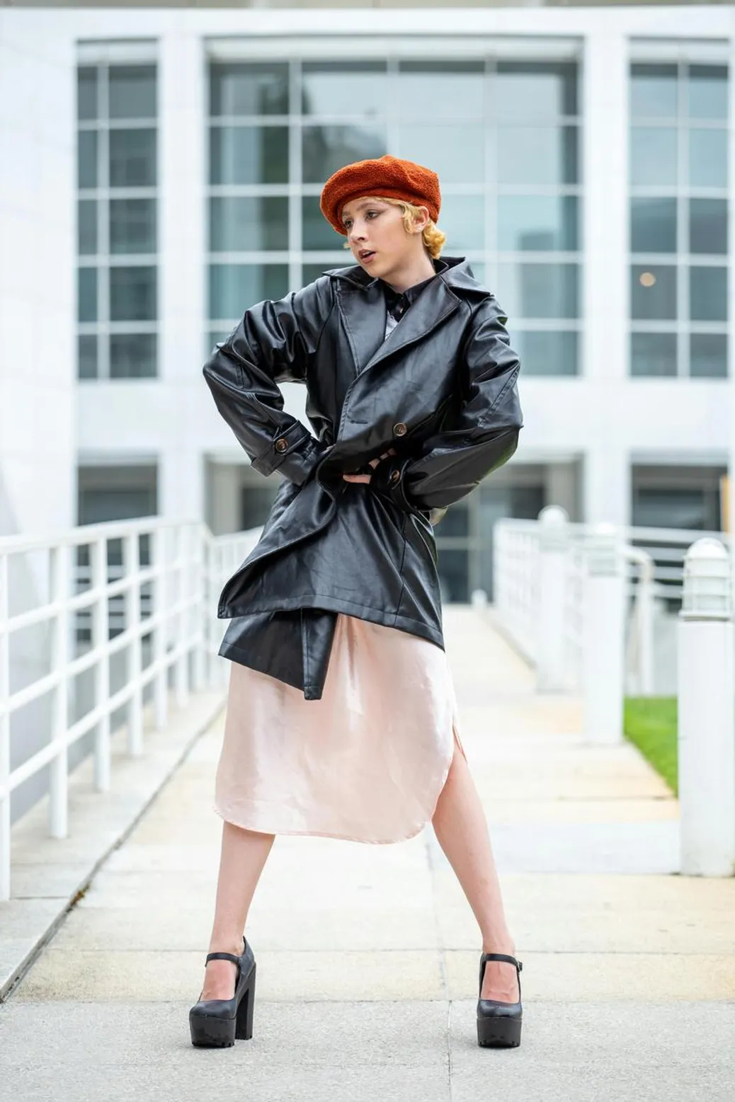 Moto jacket styled with a leather midi skirt and chunky sneakers for an edgy movie look