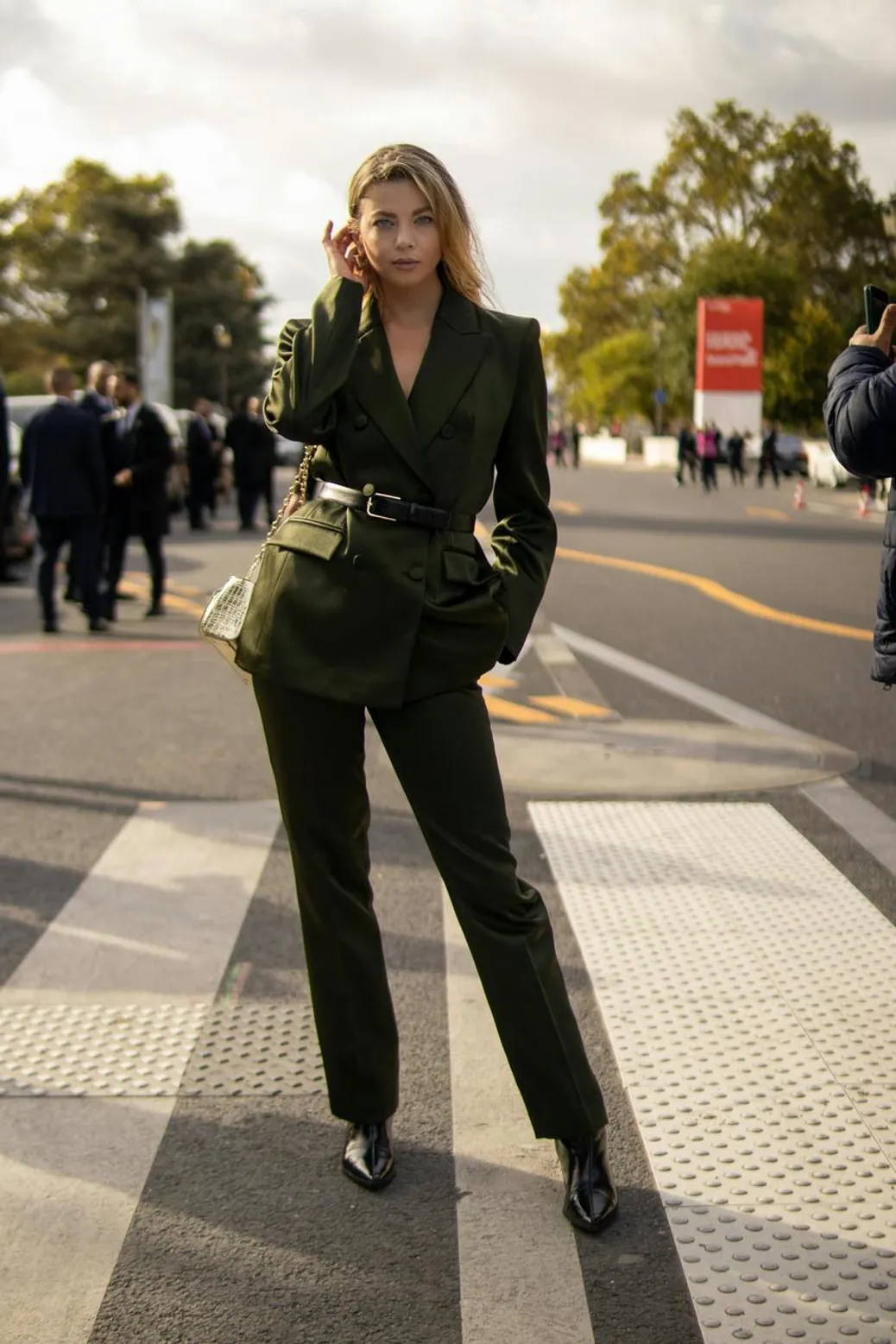 Woman wearing silk and satin pants styled with a cozy knit for a luxe yet casual look
