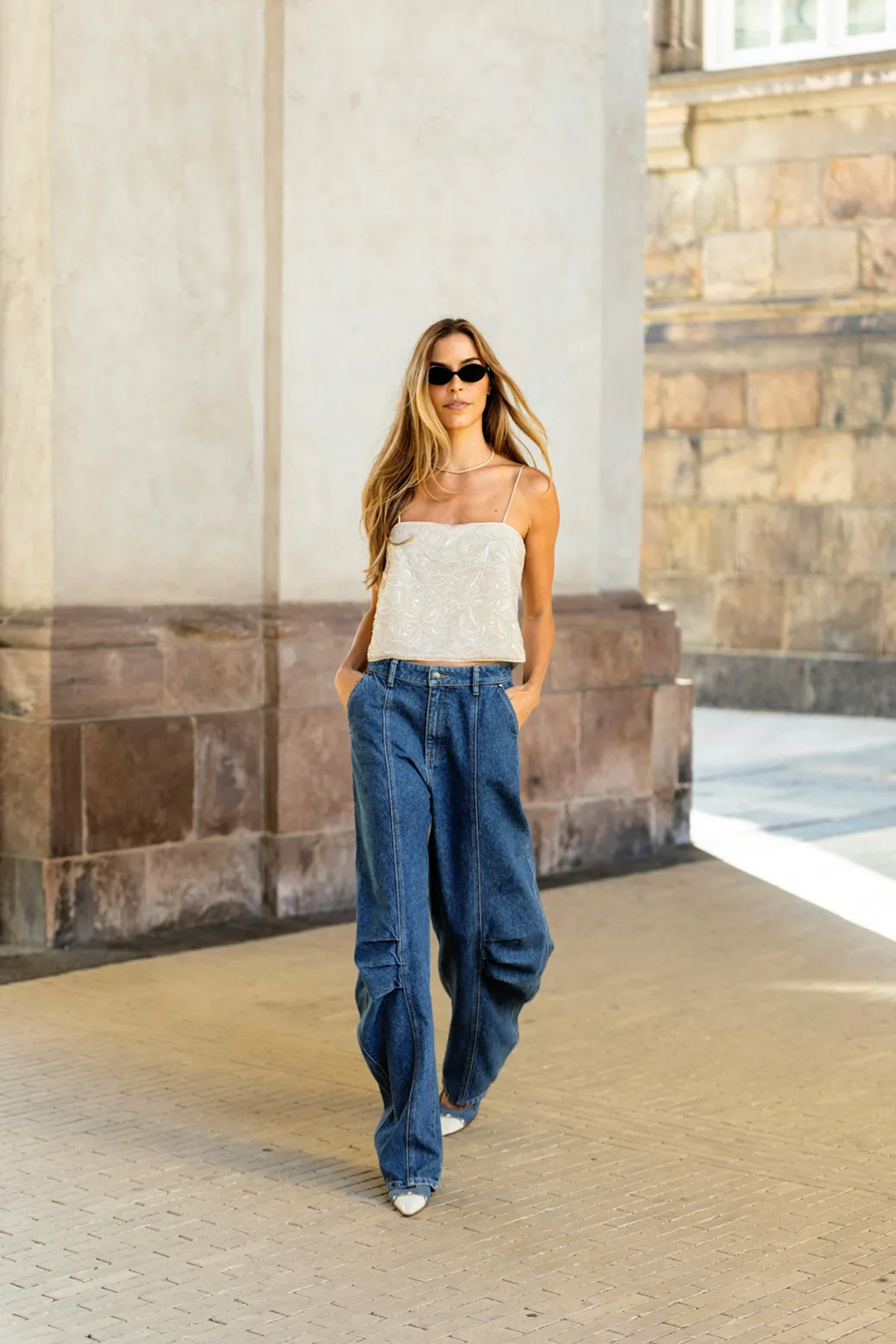 Woman in wide-leg tailored trousers paired with a blazer for a polished evening look