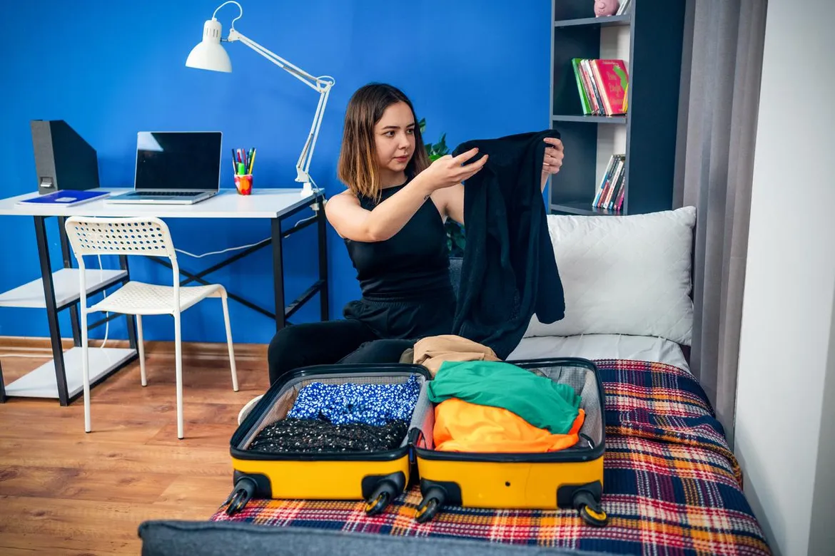 College girl organizing her wardrobe at school