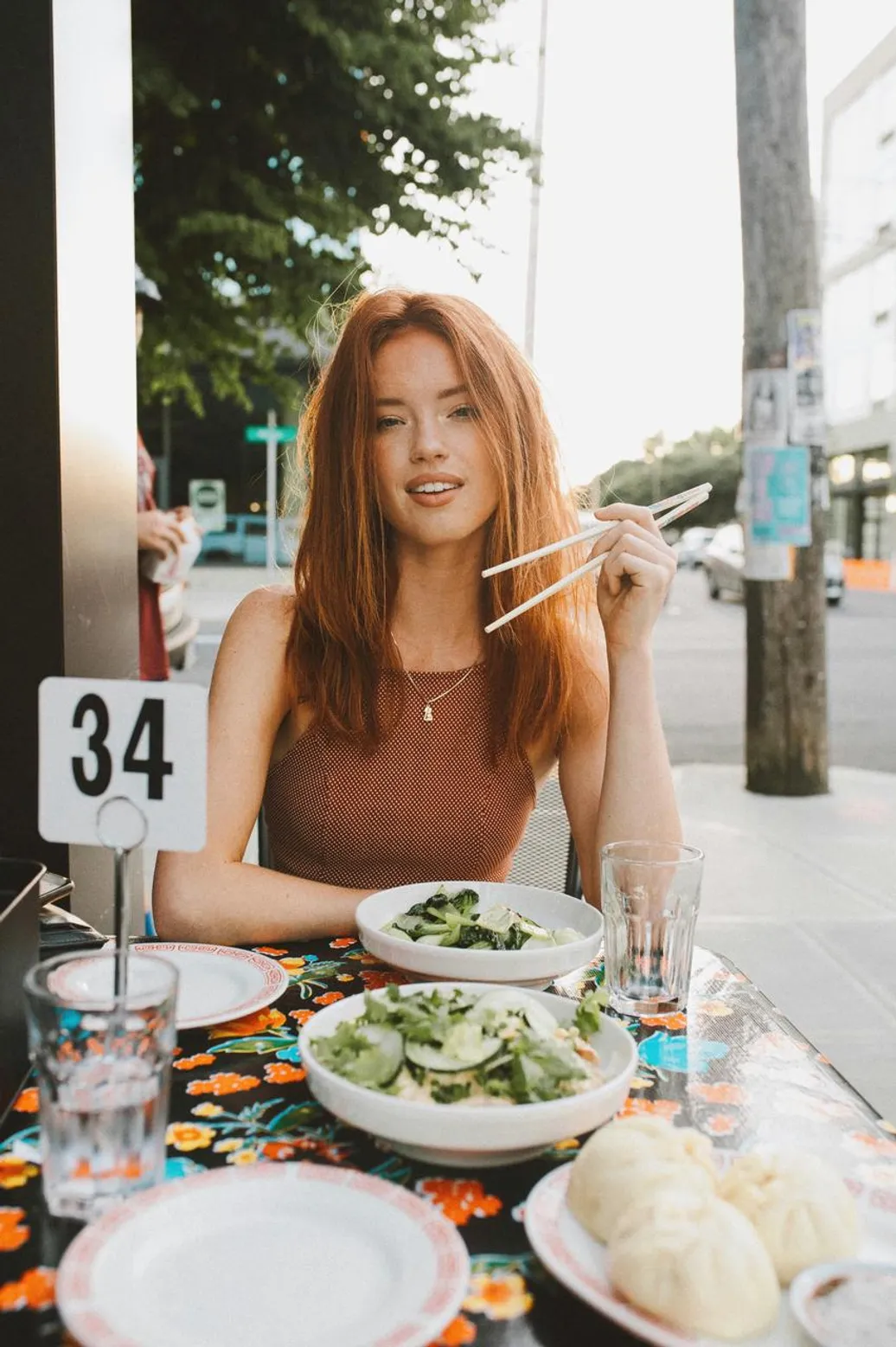 Girl in a discreet dress eating a salad