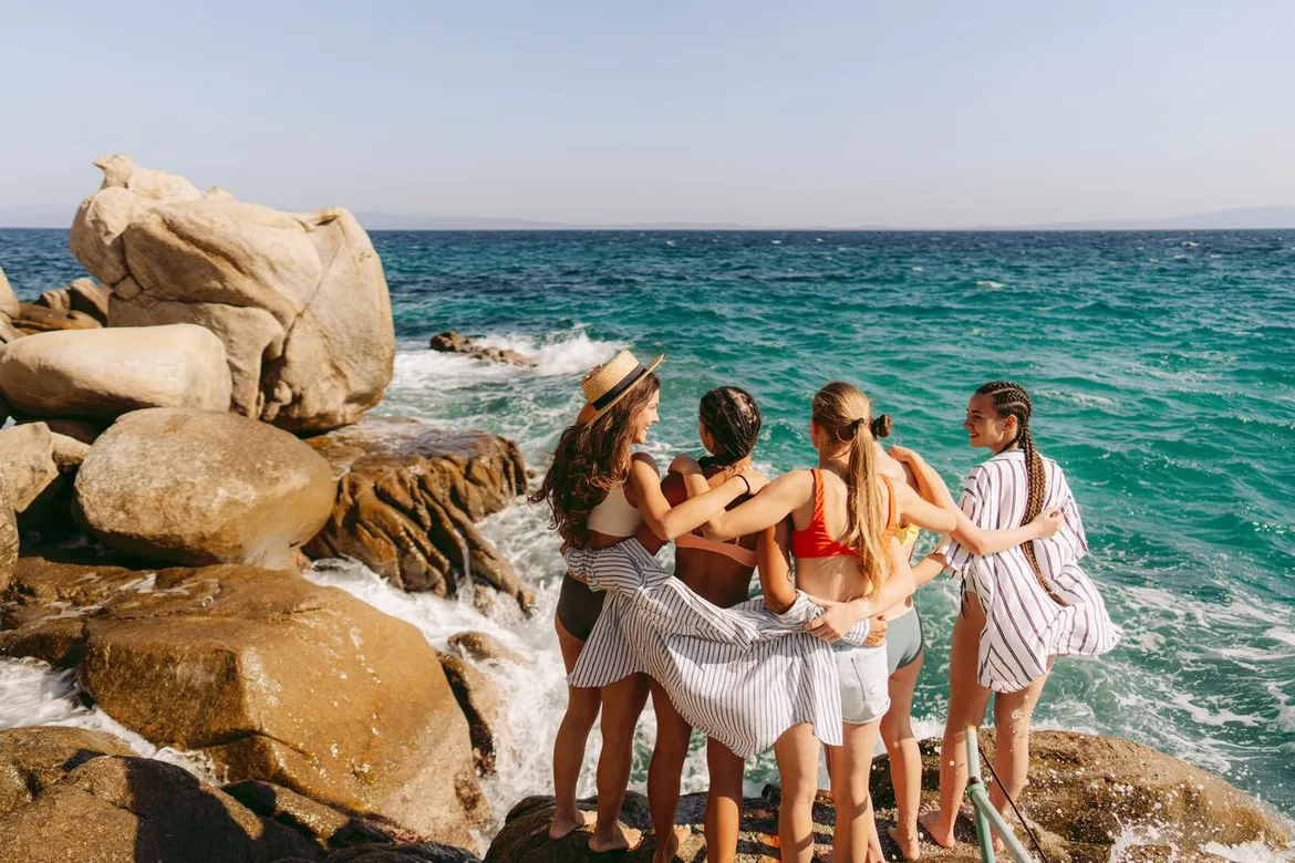 Group of girls in spring break outfits on the beach in 2025