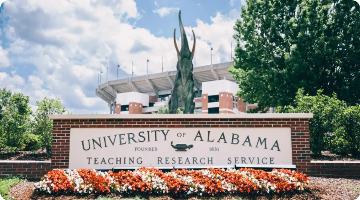 University of Alabama entrance sign with flowers